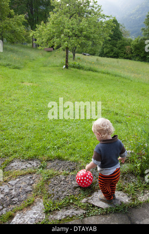 Baby boy playing with ball Stock Photo