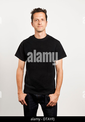 Portrait of a young man standing against white background Stock Photo ...