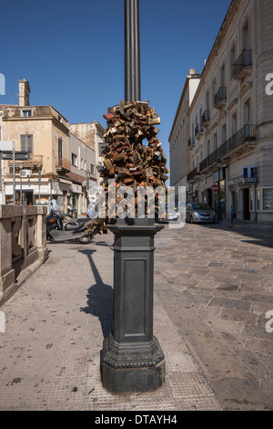 Love padlocks hanging on pole near street Stock Photo