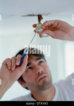 A man fixing a light Stock Photo