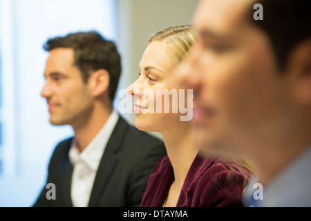 Three colleagues sitting at a business meeting, focus on pretty woman Stock Photo
