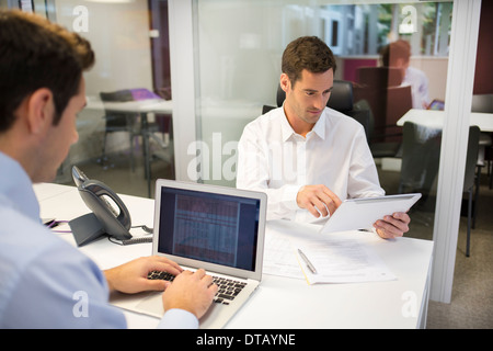 Two businessman working on computer in office, coworkers Stock Photo