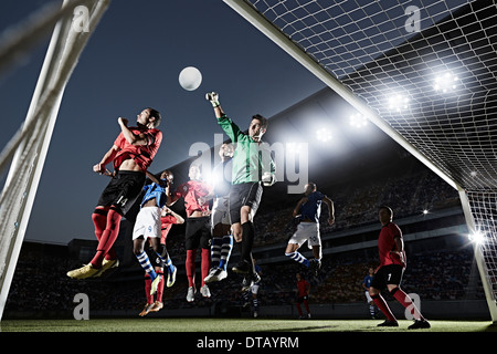 Soccer players defending goal Stock Photo