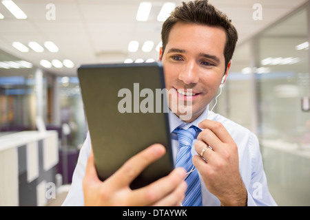 Portrait of businessman chatting in office withe digital tablet, skype Stock Photo
