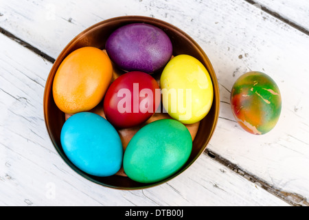 Brightly colored Easter eggs in a beautiful copper bowl Stock Photo