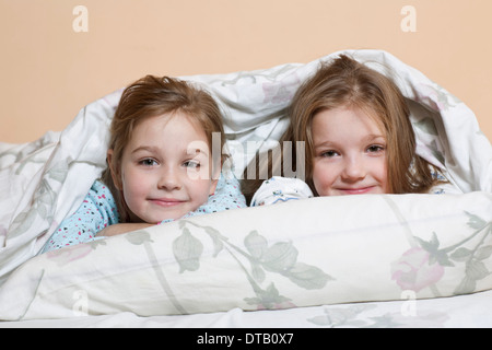 Portrait of girls relaxing on bed Stock Photo