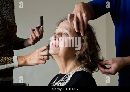 Makeup artist applying compact powder on woman face Stock Photo