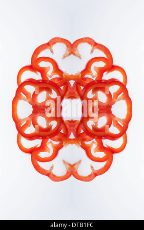 A digital composite of mirrored images of slices of red bell pepper Stock Photo