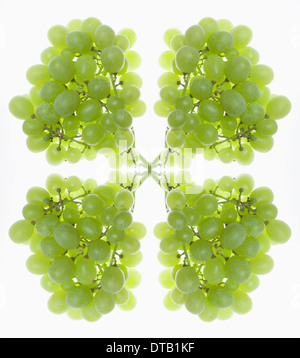 A digital composite of mirrored images of bunches of green grapes Stock Photo