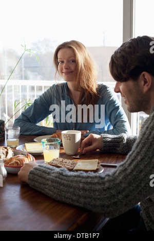 Couple having breakfast at dining table Stock Photo