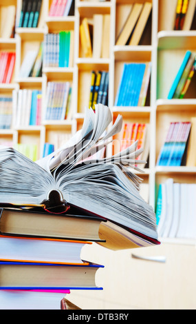 Open book lying on a stack of books Stock Photo