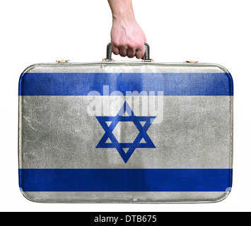 Tourist hand holding vintage leather travel bag with flag of Israel Stock Photo