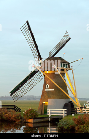 Drainage mill ''Hope springs eternal'', situated in typically Dutch flat landscape, Voorhout, South Holland, The Netherlands. Stock Photo