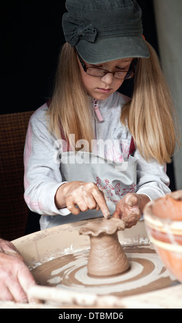 A young girl shapes a piece of pottery on potter's wheel at workshop in Lielupes Ikskile area Latvia Stock Photo