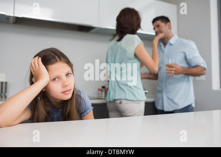 Closeup portrait of a sad girl while parents quarreling Stock Photo