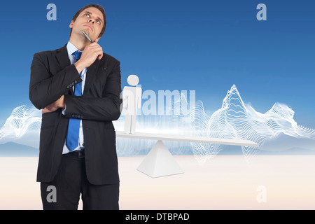 Composite image of thinking businessman holding pen Stock Photo