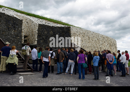 newgrange neolithic passage tomb complex ireland tour group guide guided talk listening detail overview outside monument Stock Photo