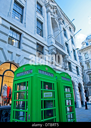 Traditional red telephone boxes painted green to celebrate Samaritans’ 60th birthday, City of London, London, Engand, UK Stock Photo