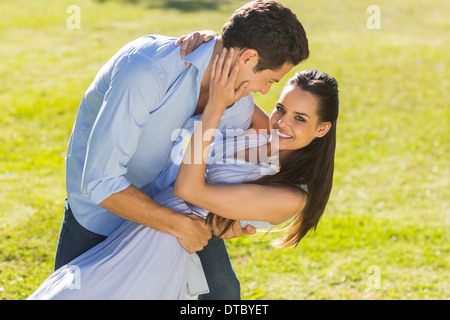 Loving and happy couple dancing in park Stock Photo