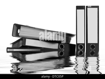 partly sunken folders on reflective water surface Stock Photo