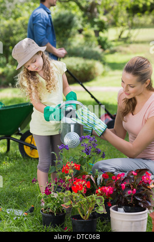 Mother with daughter watering plants Stock Photo