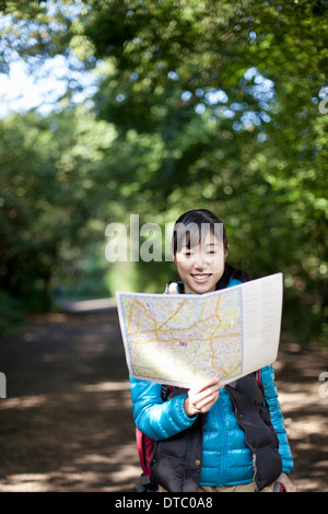 Young female hiker looking at map Stock Photo