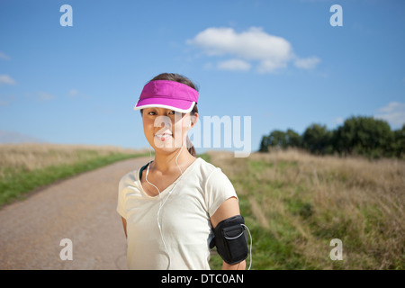 Portrait of young female runner on dirt track Stock Photo