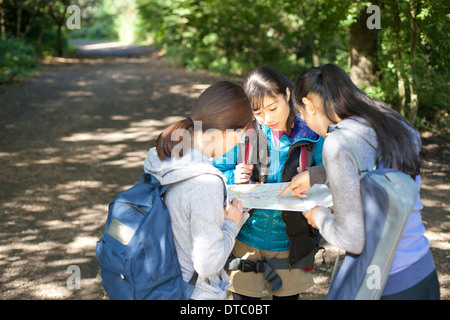 Three young female hikers looking at map Stock Photo