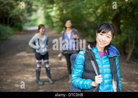 Three young female hikers on country road Stock Photo