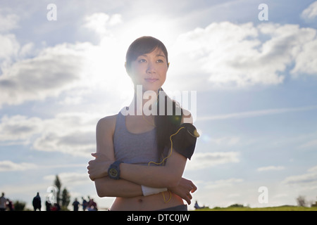 Portrait of young female runner with arms folded Stock Photo