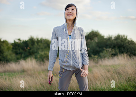 Portrait of young female runner with MP3 player Stock Photo