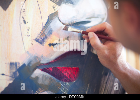 Close up of mature male artist working on canvas Stock Photo