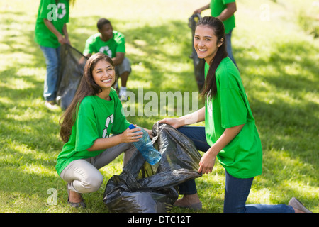 Team of volunteers picking up litter in park Stock Photo
