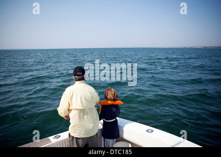 Boy and grandfather fishing from boat, Falmouth, Massachusetts, USA Stock Photo