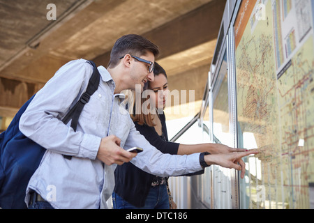 Couple looking at subway map, Los Angeles, California, USA Stock Photo