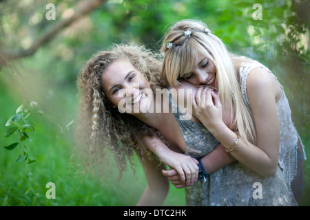 Two teenage girls having fun in woodland Stock Photo