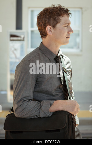 Mid adult office worker waiting at train station Stock Photo