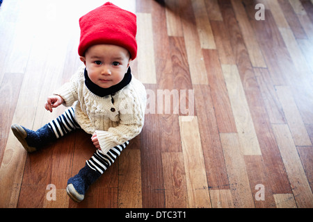Baby boy sitting on floor Stock Photo
