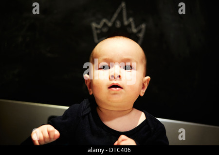 Portrait of baby boy with artist chalked crown on head Stock Photo