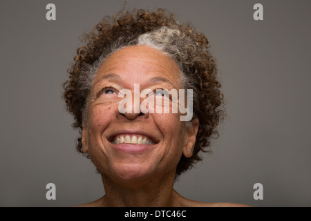 Close up studio portrait of smiling senior woman Stock Photo
