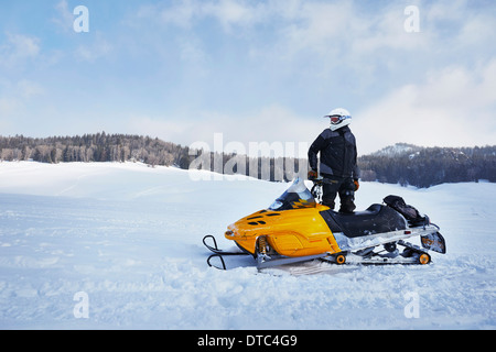 Mid adult man on snowmobile, Togwotee Pass, Wyoming, USA Stock Photo