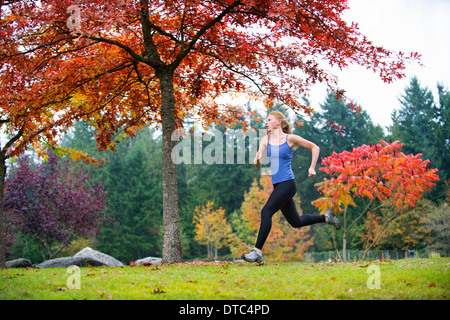 Girl jogging in forest Stock Photo