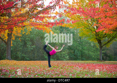 Woman practising yoga in forest Stock Photo