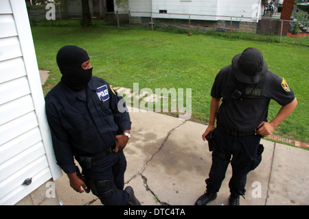 Detroit police narcotics officers rest after raiding and searching a house. Stock Photo