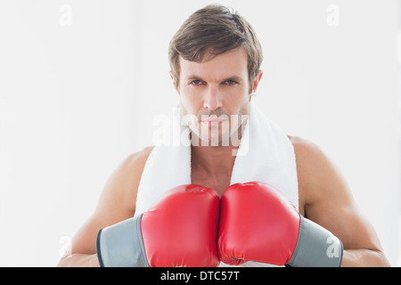 Serious young man in red boxing gloves Stock Photo