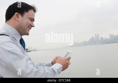 Businessman using cellular phone, Hoboken, New Jersey, USA Stock Photo