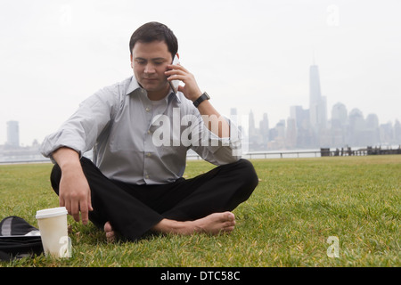 Businessman using cellular phone, Hoboken, New Jersey, USA Stock Photo
