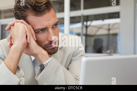 Frowning businessman looking away Stock Photo