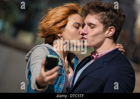 Couple taking selfies in the city Stock Photo