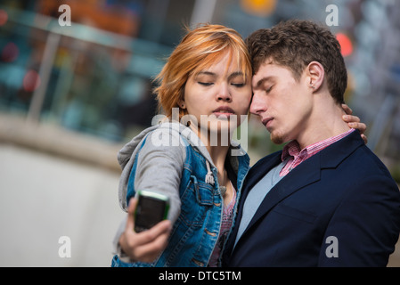 Couple taking selfies in the city Stock Photo